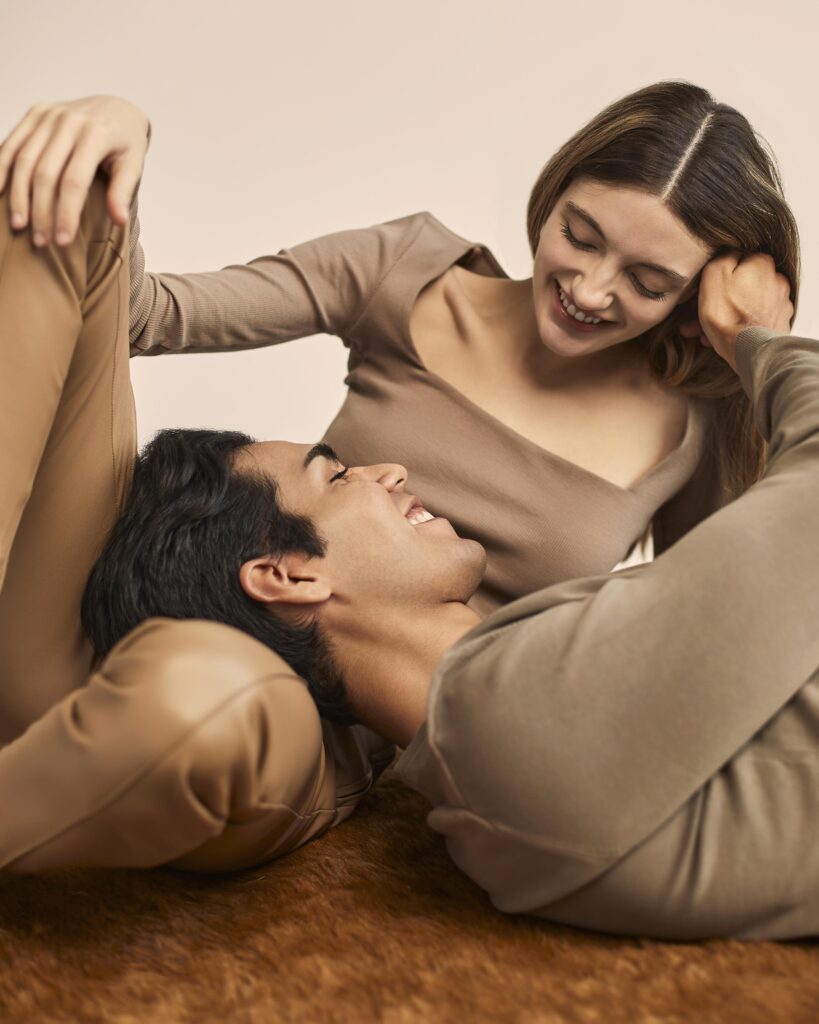 front view smiley woman with man resting his head her lap